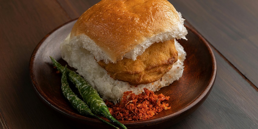 A delicious roll filled with fried meat and green chili, garnished for a tasty presentation.