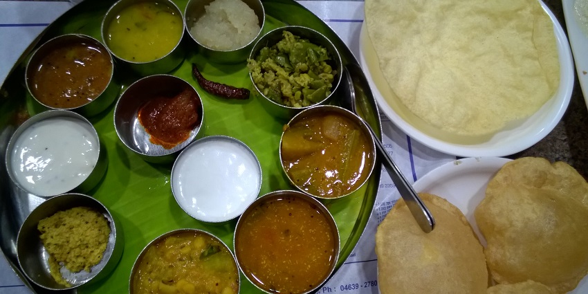 A traditional thaali from the region of Tamil Nadu filled with various dishes.
