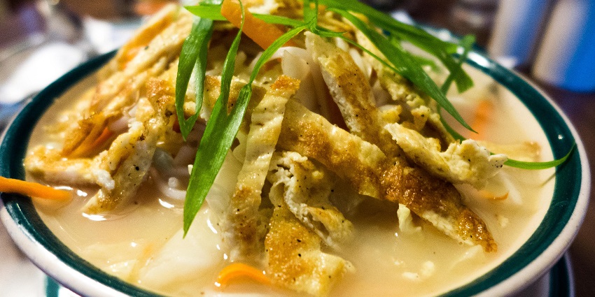 A picture of a bowl of Tibetan food with noodles and egg in it