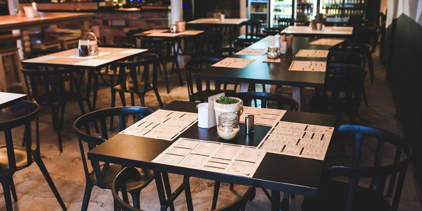 A simple dining setup with a wooden table and chair creates a warm and inviting atmosphere