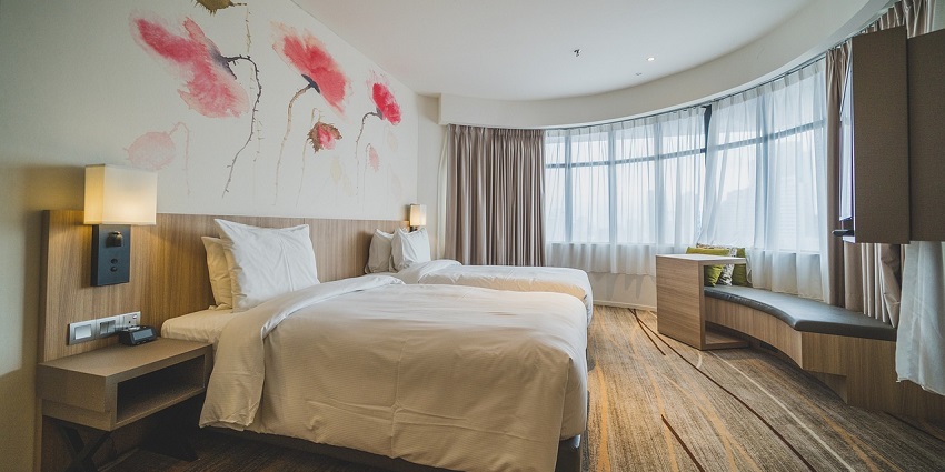 Elegant hotel room suite featuring modern decor, cosy furnishings, and a view.