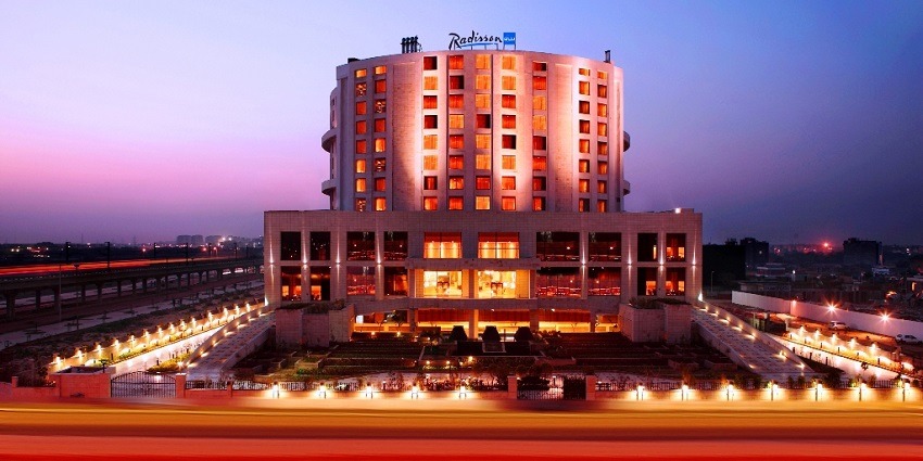 View of a multi-story hotel building with glass windows and a modern architectural design.