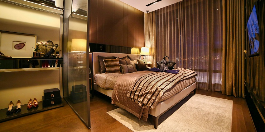 Hotel room featuring a large bed, and warm lighting, creating a welcoming atmosphere.