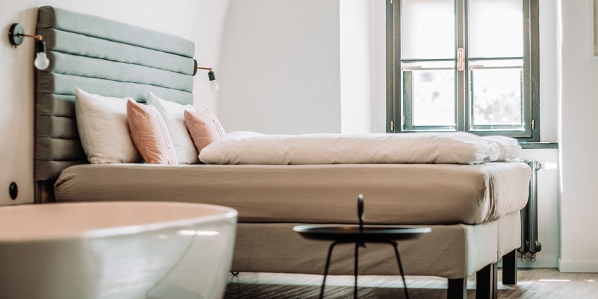 The cosy hotel room features modern decor and comfortable furnishings with cushions