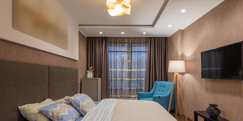 An image of a cosy hotel room featuring a large bed, modern decor, and soft lighting.