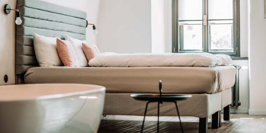 The cosy hotel room features modern decor and comfortable furnishings with cushions