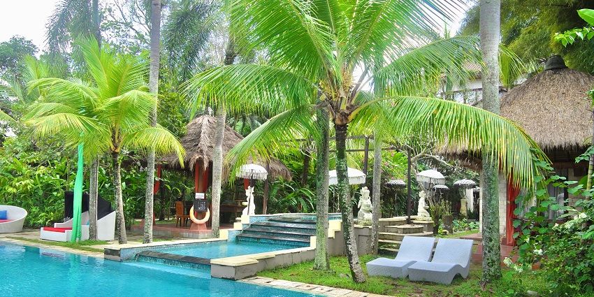 A hotel courtyard and palm trees in the background, creating a serene coastal atmosphere