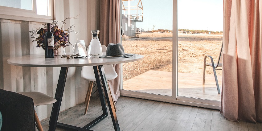 A room in a hotel with a view of the island visible with clear weather and beautiful surroundings.