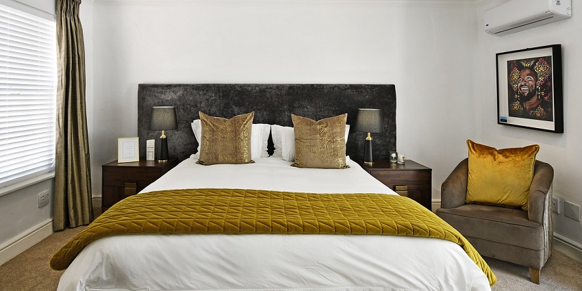 Comfortable hotel bedroom with a neatly made bed, inviting a restful sleep experience