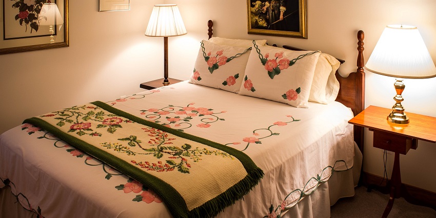 A welcoming guest bedroom featuring a plush bed, warm decor, and soft lighting.