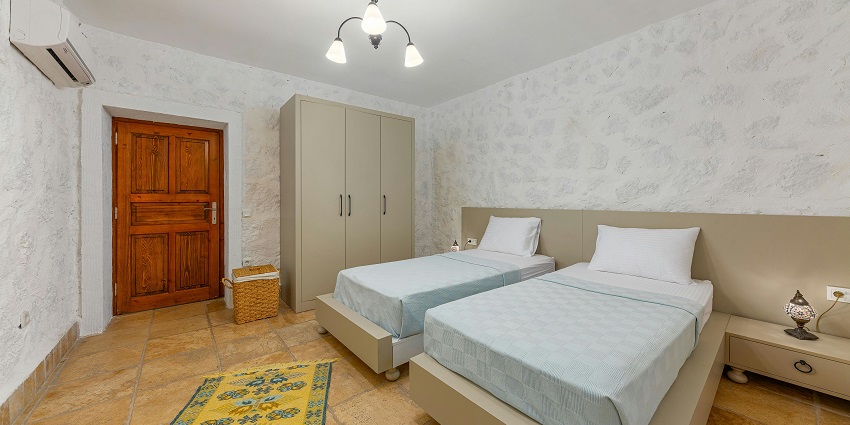 Elegant hotel room with soft double beds, designed for ultimate relaxation and comfort.
