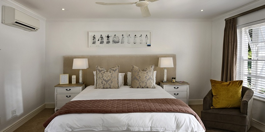 Modern hotel room with a cosy bed, stylish decor, and warm ambient lighting