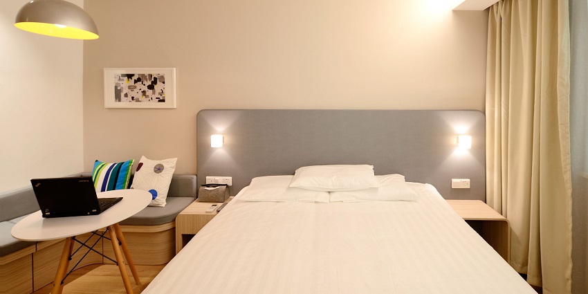 Elegant hotel room suite featuring modern decor and cosy furnishings.