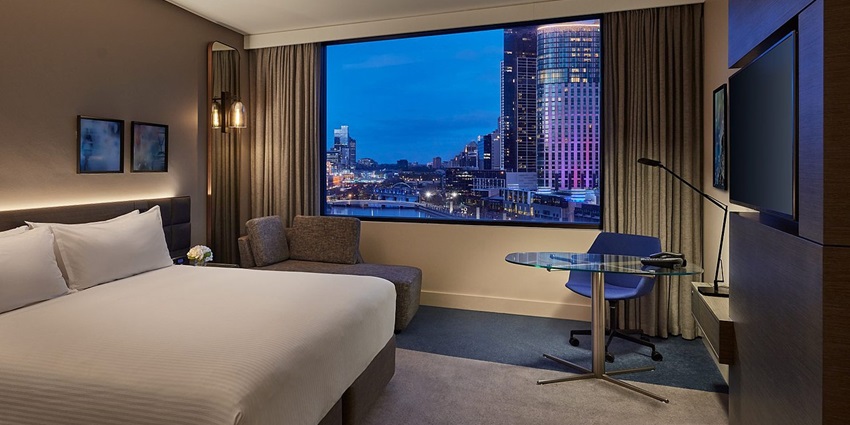 Interior view of a hotel room, featuring modern decor and lighting.