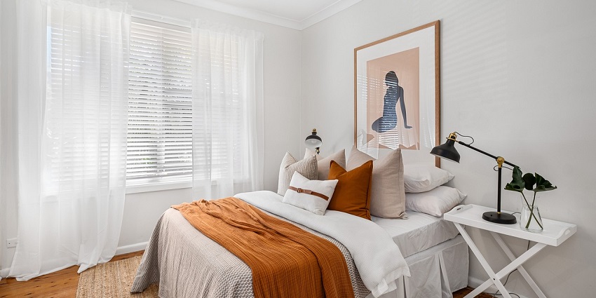 A stylish bedroom with modern furniture, a cosy bed, and elegant decor in neutral tones.
