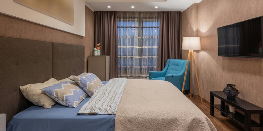 Stylish hotel room interior featuring modern decor, a large bed, and an inviting ambience.