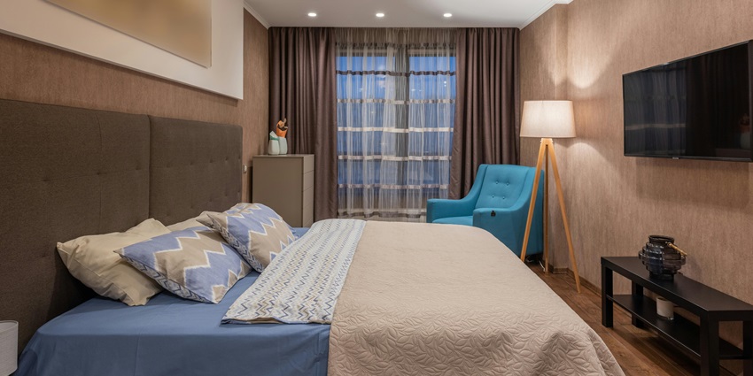 Stylish hotel room interior featuring modern decor, a large bed, and inviting ambiance