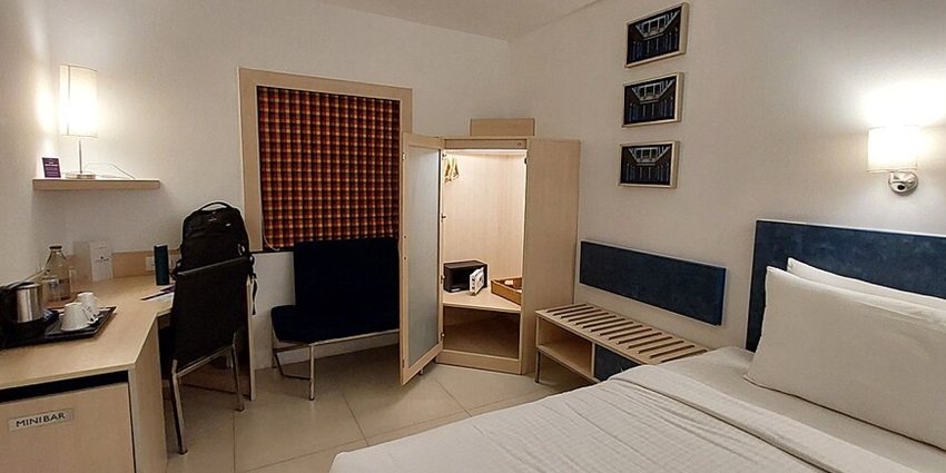 The clean bedroom of a hotel near Ashtalakshmi Temple in Chennai, Tamil Nadu.
