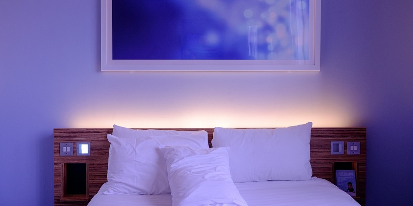 Stylish hotel room featuring a neatly made bed designed for comfort and relaxation.