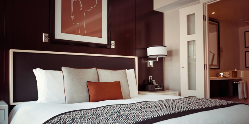 Black and grey bedspread on a bed with a matching pillow, creating a cozy ambiance.