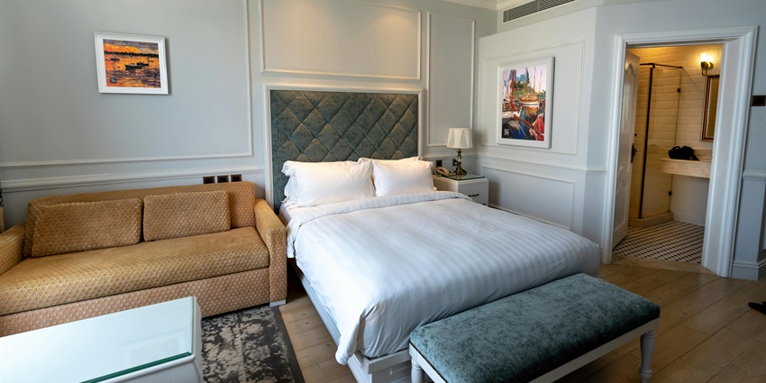 A cosy hotel room featuring a comfortable bed and elegant decor