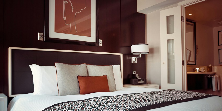 Stylish black and grey bedspread elegantly draped over a plush hotel bed.