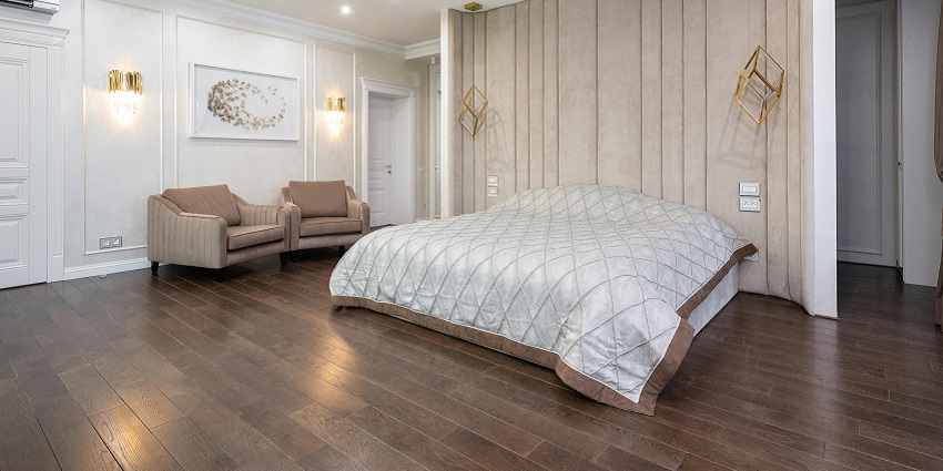 A cozy bedroom featuring armchairs next to a bed, creating a warm and inviting space.