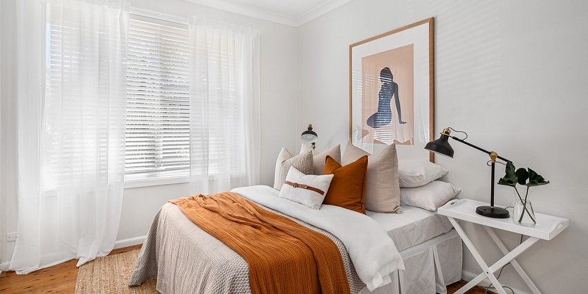 A stylish bedroom with modern furniture, a cosy bed, and elegant decor in neutral tones.