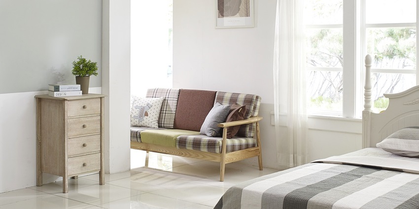 Comfortable bedroom featuring a stylish cupboard and a neatly made bed for relaxation.