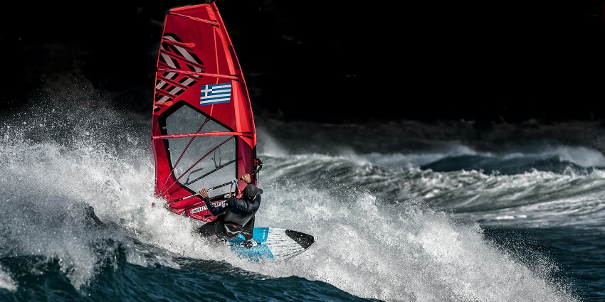 An image of a windsurfer gliding across the waves, one of the top Mandwa Beach water sports.