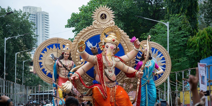 A picture of the celebration of Ganesh Chaturthi on the streets of Mumbai with colours and music