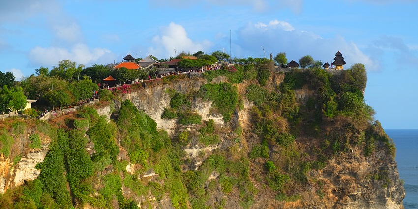 A distant view of Uluwatu Temple situated on a cliff of Bukit Peninsula in Indonesia.