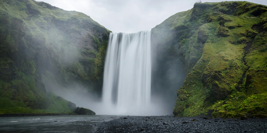 Stunning cascades of the Sukeli waterfalls, with mist and greenery surrounding