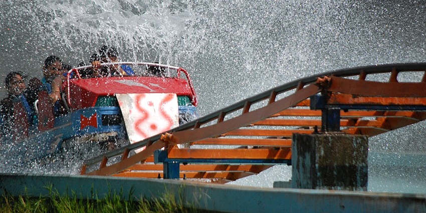 Thrill-seekers enjoying giant water rides at a water park in Uttar Pradesh