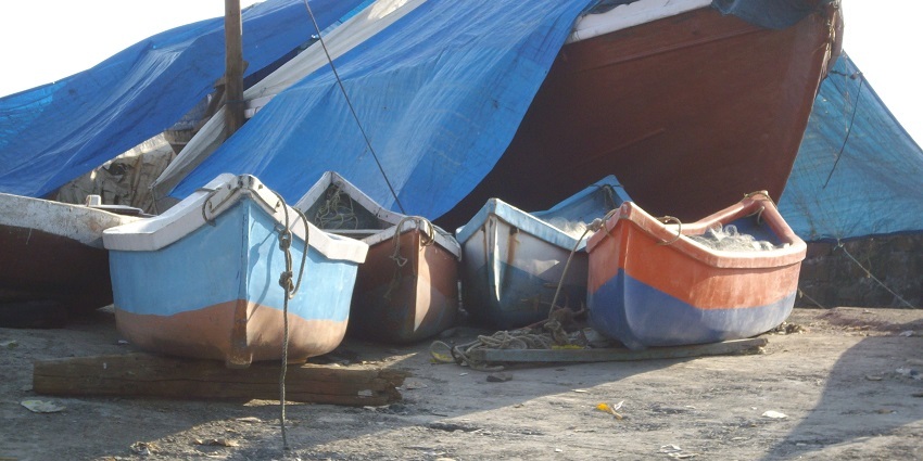 Fishing boats in a lake at Worli Village on a clear day in Mumbai, India