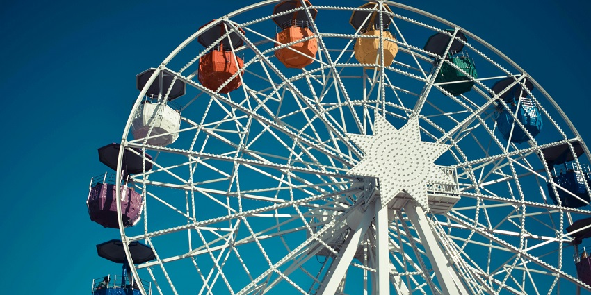 Stunning white steel Ferris wheel spinning joyfully, just like Yazoo Park's attraction.