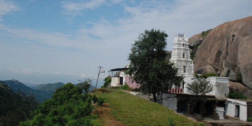 Yoga Narasimha Temple in Devarayanadurga, surrounded by lush greenery and hills.