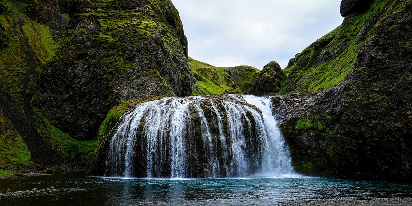 A landscape of a majestic waterfall, a tourist attraction near the Arctic seasonal waterfall.