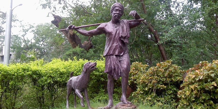 View of a sculpture of a Gowari man in traditional getup with his dog at Zero Mile Marker.