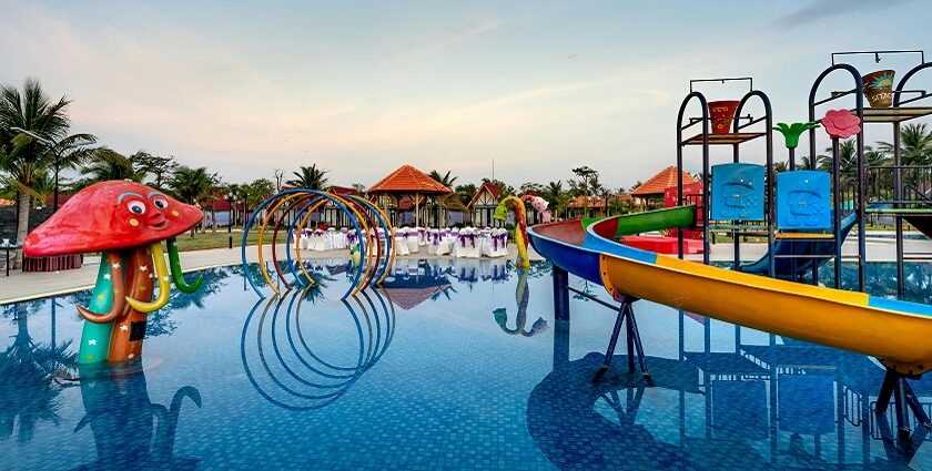 Children squealing with delight while sliding down colourful water slides at the water park in Pune