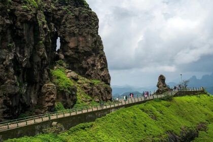 View of Mahabaleshwar, highlighting its rolling hills and vibrant landscape under the sky.