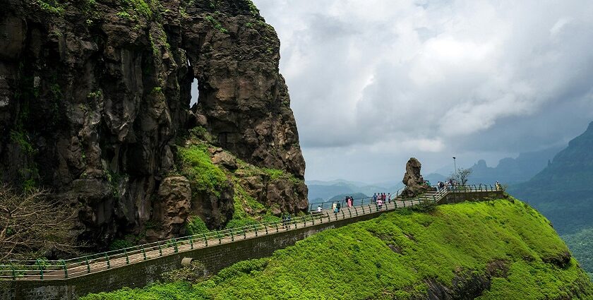 View of Mahabaleshwar, highlighting its rolling hills and vibrant landscape under the sky.