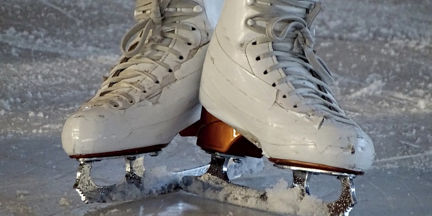 Indoor ice skating rink at iSKATE, offering a fun experience with music, and ice activities.