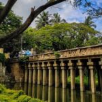 A breathtaking vista of a historic bridge surrounded by lush greenery in Karnataka.