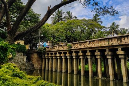 A breathtaking vista of a historic bridge surrounded by lush greenery in Karnataka.