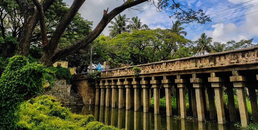 A breathtaking vista of a historic bridge surrounded by lush greenery in Karnataka.