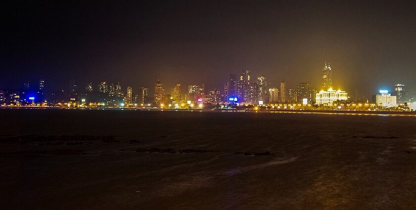 A picture of the Mumbai skyline, featuring illuminated buildings and the iconic curve of the Queen's Necklace.