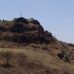 Rangana Fort, surrounded by dense vegetation and hills, a historic tourist attraction near Maharashtra.