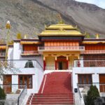 A breathtaking view of a monastery with stunning architecture surrounded by hills.