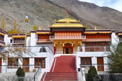 A breathtaking view of a monastery with stunning architecture surrounded by hills.